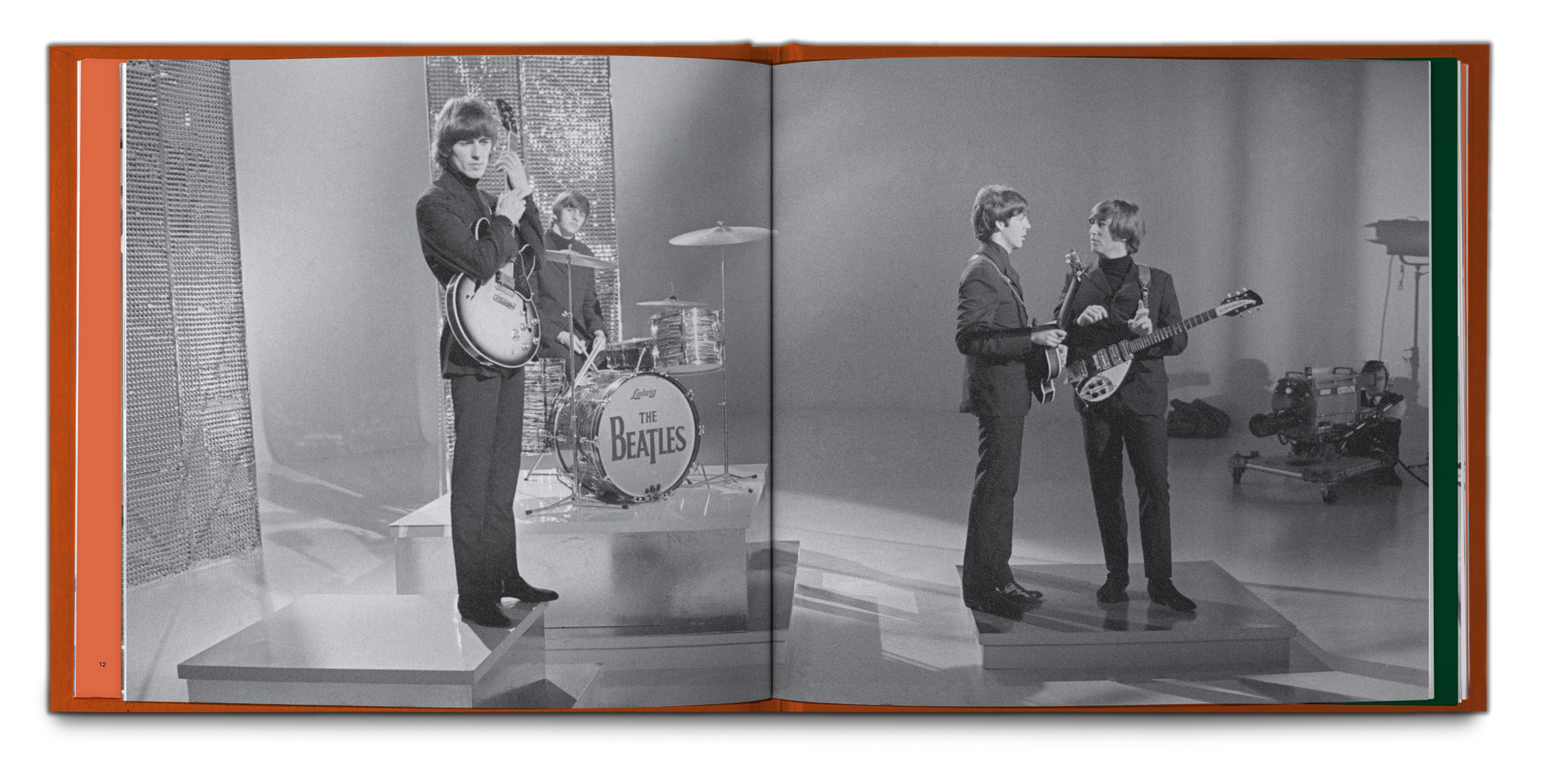An open book or photo album showing a black-and-white printed photograph of The Beatles performing on stage, photographed against a plain white background. The Book that is included in the 5LP Box Set Exclsuive