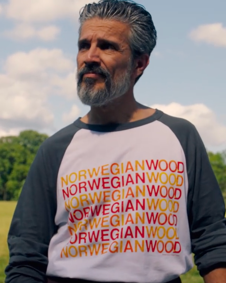 A man outdoors wearing Rubber Soul Norwegian Wood Raglan